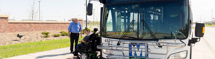 Driver and Passenger Outside of Bus - New Large Hero Image 2024